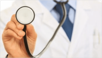 Close-up of a doctor's hand holding a stethoscope, with the diaphragm facing the viewer. The doctor is wearing a white coat, light blue shirt, and dark blue tie, with only part of the upper body visible in the image.