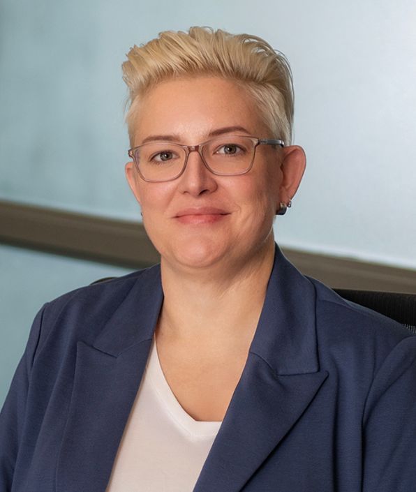 woman with short blond hair and glasses