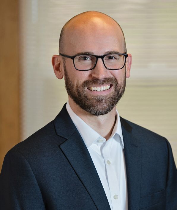 bald man with brown beard and glasses