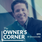 A smiling man with short curly hair is wearing a suit jacket and collared shirt. Text on the image reads: "The Owner's Corner, EP3, Al Grossnickle." The background features a modern office setting with large windows and blue-tinted geometric shapes.