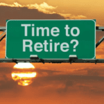 A green road sign reads "Time to Retire?" with a picturesque sunset and clouds in the background. The sun is partially visible, creating a warm and serene atmosphere, inviting thoughts of exiting corporate life for something more tranquil.