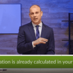 A man in a suit is giving a presentation in a room with wooden walls and shelves filled with books and decorative items. A text overlay at the bottom of the image reads, "Inflation is already calculated in your plan.