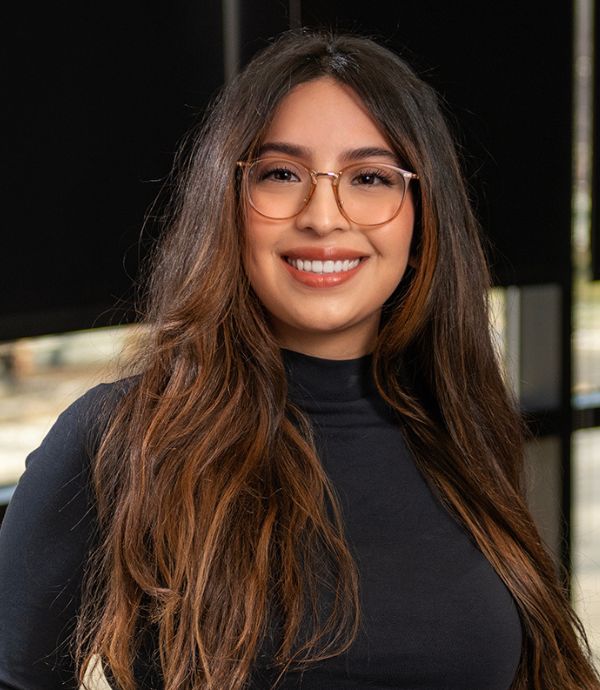 brunette female smiling with glasses