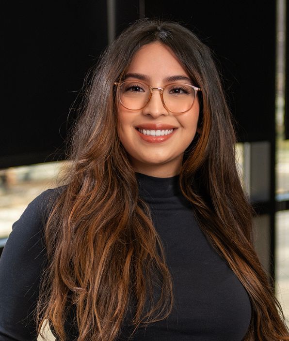 woman with long dark hair and glasses