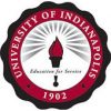 Seal of the University of Indianapolis, featuring a red and white circular design with the university name and founding year, 1902, surrounding a torch icon and the motto "Education for Service.