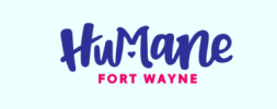 Image of the Humane Fort Wayne logo. The word "Humane" is written in a playful, blue font with a small heart shape in the middle of the "M". Below, "FORT WAYNE" is written in pink, uppercase letters. The background is light blue.