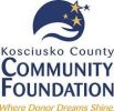 Logo of the Kosciusko County Community Foundation. A blue emblem at the top features a hand cradling three gold stars. Below, stylized text reads "Kosciusko County Community Foundation" with the tagline "Where Donor Dreams Shine" in gold at the bottom.