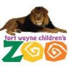 Logo of Fort Wayne Children's Zoo featuring a lion lying down on top of stylized text. The words "fort wayne children's" are above, and the word "ZOO" is in large letters below, with each letter in a different color and whimsical design.