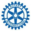 The image shows the Rotary International logo, consisting of a blue gearwheel with six spokes. The words "ROTARY INTERNATIONAL" are written in blue around the inside perimeter of the gear. A smaller circular design is in the center.