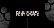 A black background with the text "Purdue University Fort Wayne" in bold, white letters. The words "Purdue University" are in white, and "Fort Wayne" is in gold beneath. There are faint, large paw prints in gray visible on both sides of the text.