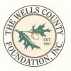 Logo for The Wells County Foundation, Inc. featuring a circular design with the text "THE WELLS COUNTY FOUNDATION, INC." around the perimeter, and an image of green oak leaves and an acorn in the center with "EST. 1957" next to it.